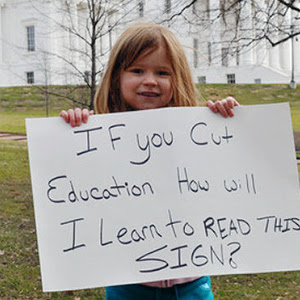 girl holding sign about
                                          education funding