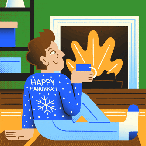 Image of someone in front of a fire place with the words "happy hanukkah" written