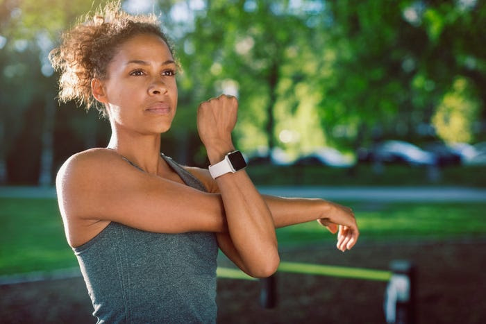 toned woman in park, getting ready to run