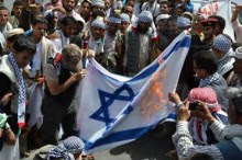 Palestinian Arabs burn Israeli flag.