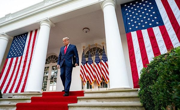 Donald Trump walking down the stairs of the White House
