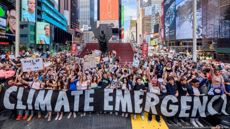 Protest crowd holding Climate Emergency sign