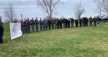 ECOs and law enforcement stand in a line during memorial