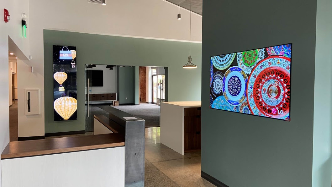 A flat screen tv sitting in a room Description automatically generated