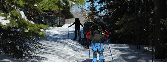 Three cross country skiers approach the Haskell Hut