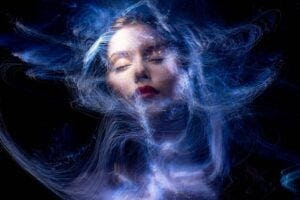 Illustration of a woman's face, eyes closed, amid a digital swirl. Pixabay