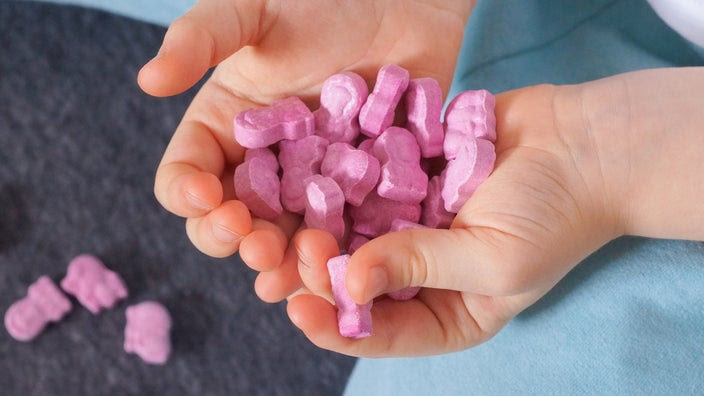 A child holds animal-shaped vitamins. Children and adults can overdose on vitamins. Learn how many are too many vitamins and what you can do in case of a vitamin overdose.