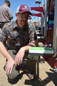 Dr. Seth Murray, Texas A&M AgriLife Research corn breeder, College Station, looks over one of the sensors used as part of a ground phenotyping vehicle used in collecting real-time crop data. (Texas A&M AgriLife Research photo by Blair Fannin) 