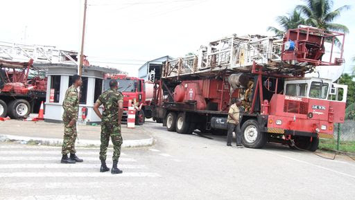 Soldiers on guard at the former Petrotrin administration building in Santa Flora yesterday.