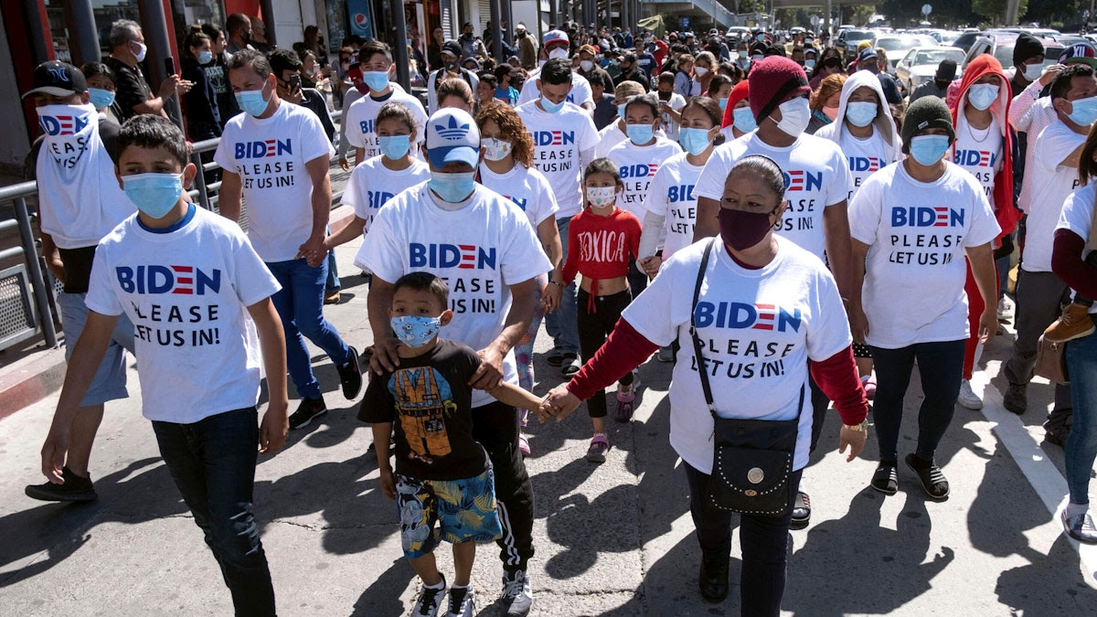 Large Number Of Migrants Arrive At U.S.-Mexico Border Wearing Biden T-Shirts: ‘Please Let Us In!’