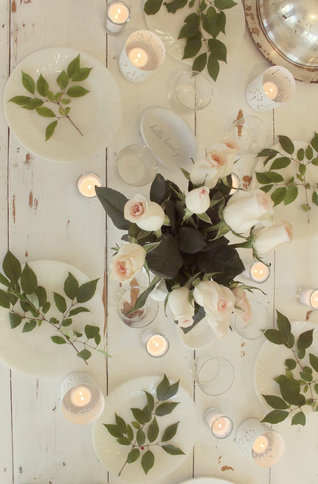 Inspiring romantic and Scandinavian tablescape with lush roses on white farm table by Hello Lovely