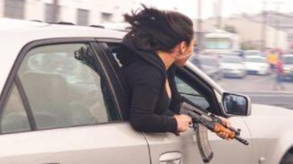 A woman is seen leaning out the passenger window with an AK-47 in San Francisco