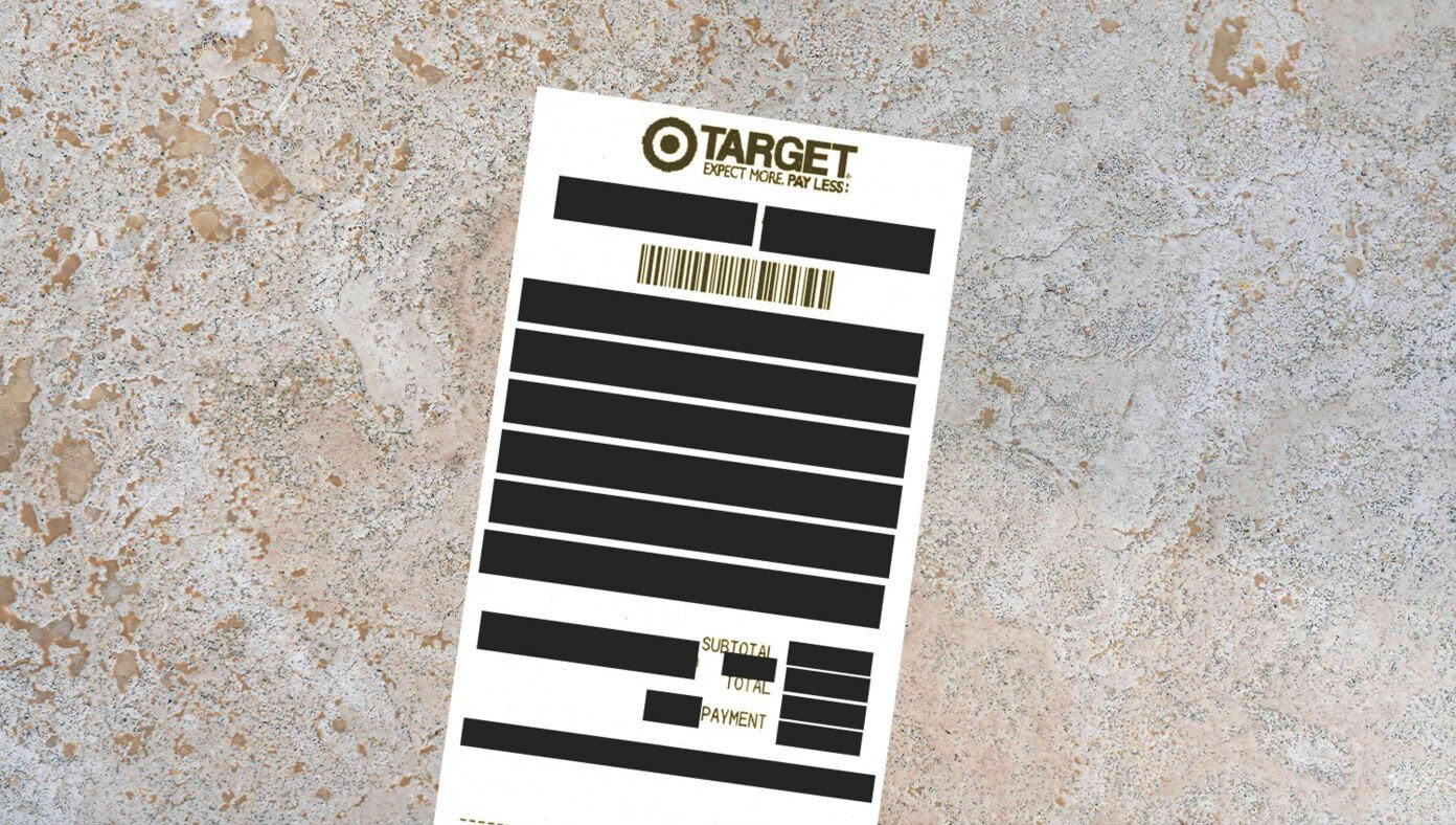 Wife Hands Husband Target Receipt With Classified Purchases Redacted