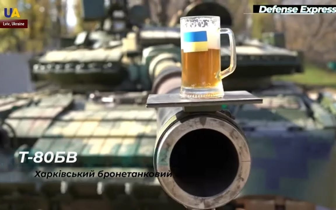 The gun of a tank balancing a beer