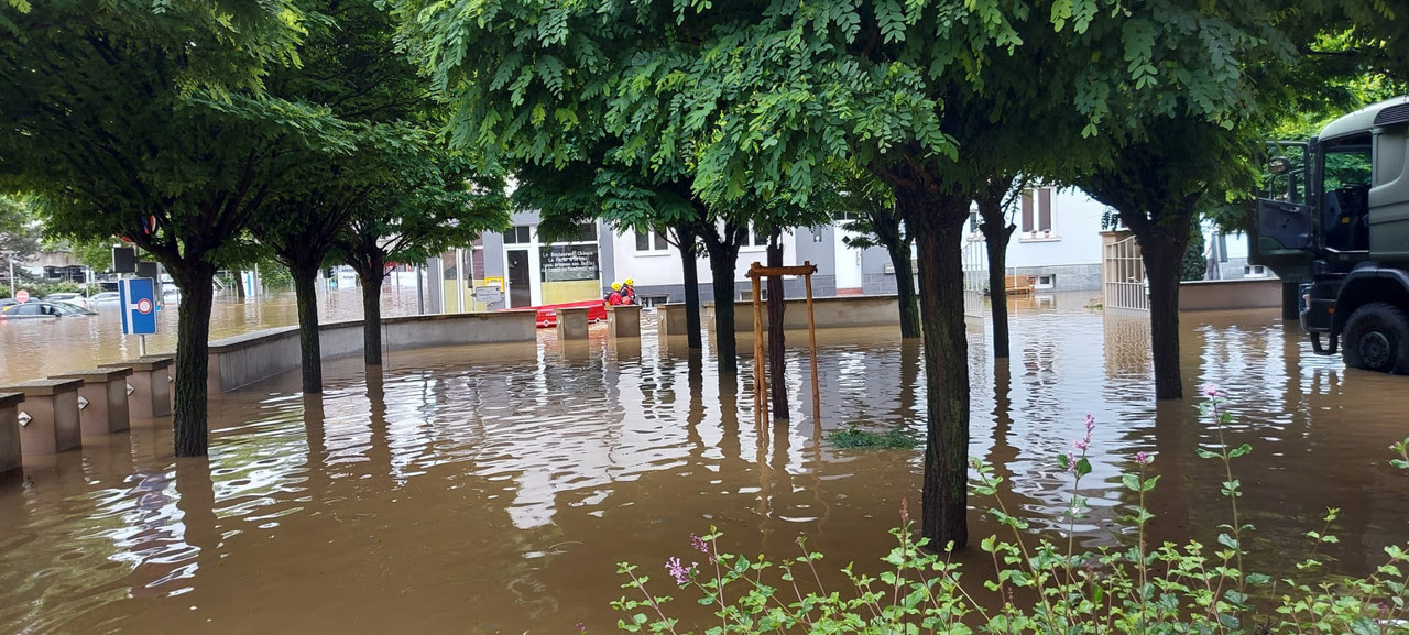 A 15 July 2021 photo shows helpers pulling a boat along a flooded street in front of the CNL in Mersch  Photo: CNL
