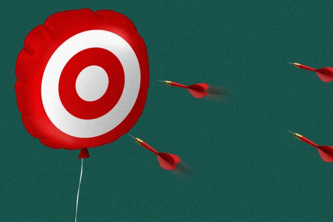 Target logo on a balloon with darts going toward it