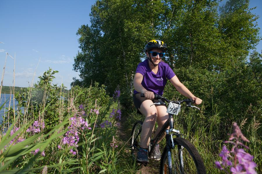 A woman cycles on a trail ride