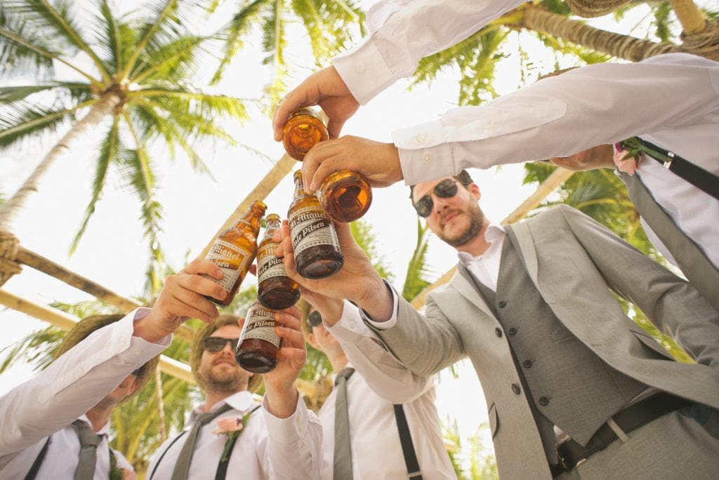 Groomsmen having a toast with beer