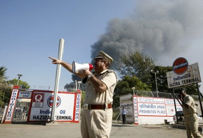 The public face of government: a police officer directs the response to a fire in Hazira, India. Greater public trust in officialdom builds domestic resilience (Photo: Reuters/Amit Dave).