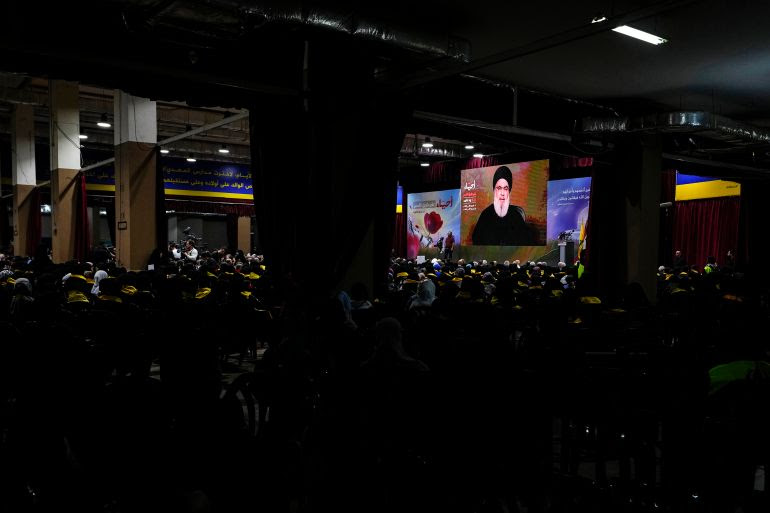 Supporters of the Iranian-backed Hezbollah group listen to a speech by Hezbollah leader Sayyed Hassan Nasrallah via a video link, during a ceremony marking the "Hezbollah Martyr Day," in the southern Beirut suburb of Dahiyeh, Lebanon, Saturday, Nov. 11, 2023. (AP Photo/Hassan Ammar)