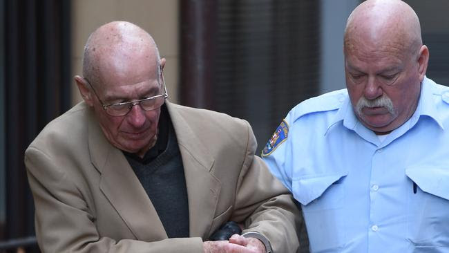 Former detective Roger Rogerson is escorted to a prison van at the Supreme Court in Sydney, Wednesday, June 15, 2016. Rogerson has been found guilty of the murder of Jamie Gao.