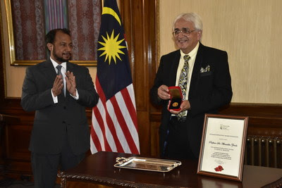 Prof. Sir Alimuddin Zumla (right) receives the 2020 Mahathir Science Award from Mr. Zahid Rastam (left), Chargé d'Affaires at the Malaysian High Commission in London. Prof. Sir Alimuddin Zumla (right) receives the 2020 Mahathir Science Award from Mr. Zahid Rastam (left), Chargé d'Affaires at the Malaysian High Commission in London.