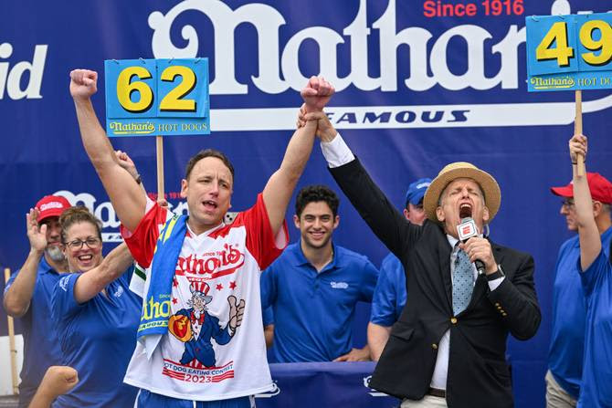 Defending champion Joey Chestnut cheers after finishing in first place in the 2023 Nathan's Famous Fourth of July International Hot Dog Eating Contest