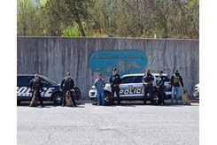 Ruidoso Downs president and general manager Jeff True (center) with local law enforcement K-9 units