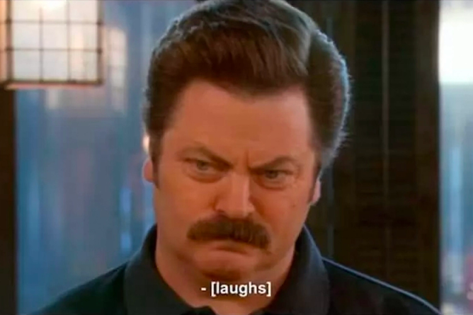 Ron Swanson scowling in Parks and Rec, with the subtitle showing "laughs"