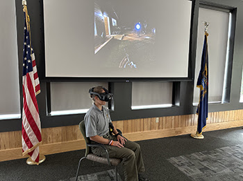 coservation officer in virtual reality headset with scenario on screen above