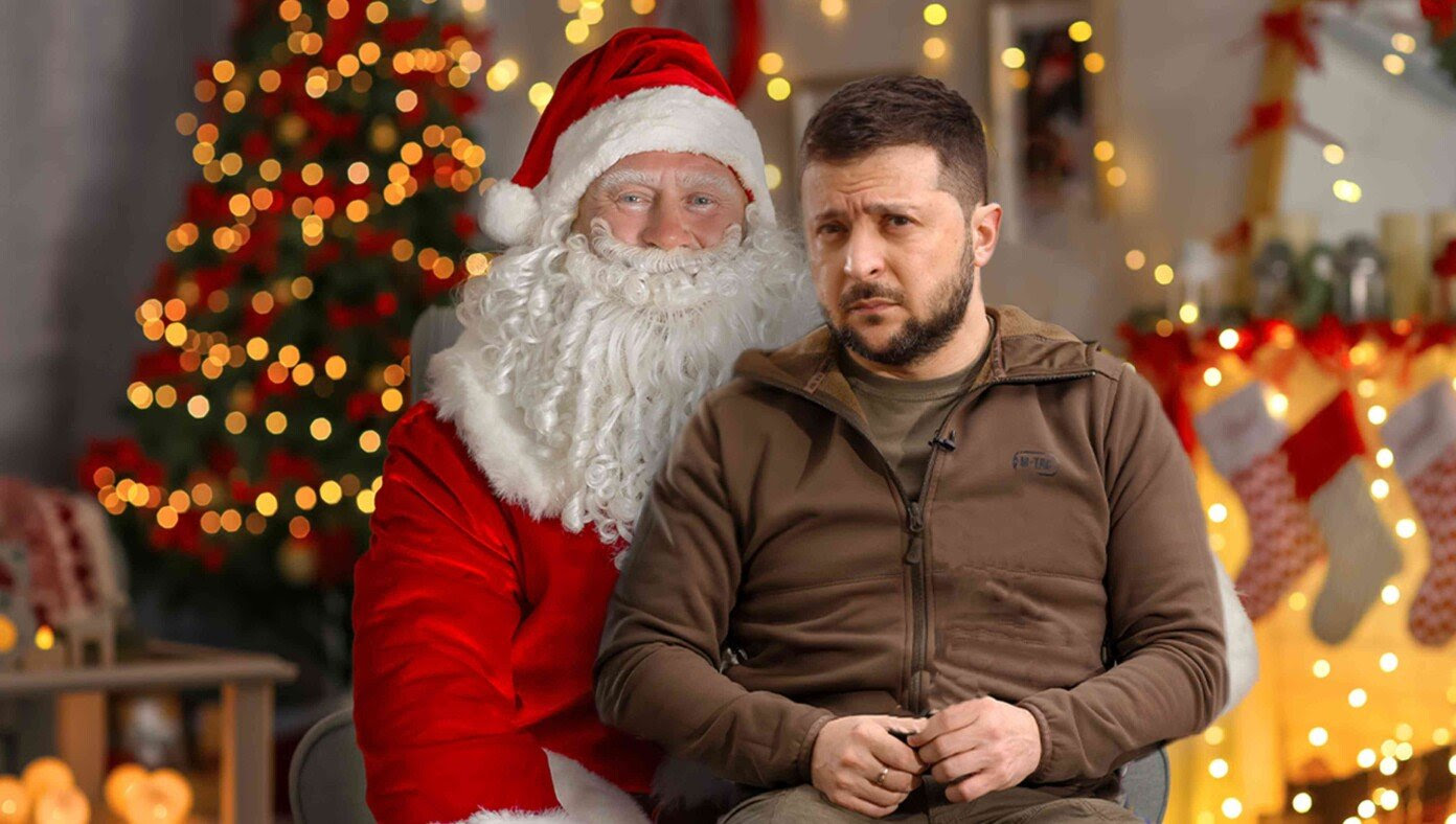 Zelensky Seen Sitting On Mall Santa’s Lap Asking For Another $50 Billion