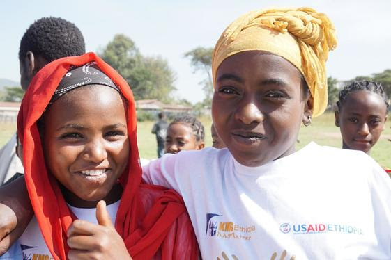 Two women give a thumbs-up