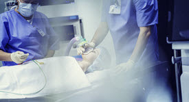 Doctors performing a procedure on a child in the operating room