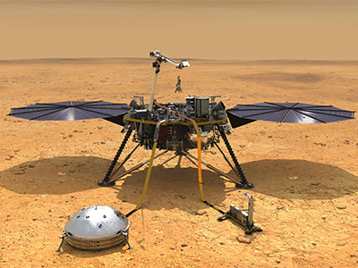 Illustration shows the Mars InSight lander on the reddish-golden Mars soil, with a shadow of its solar panels, and a lighter brownish horizon in the background. In front of the lander, two science instruments rest on the ground, each tethered to main body of the spacecraft.