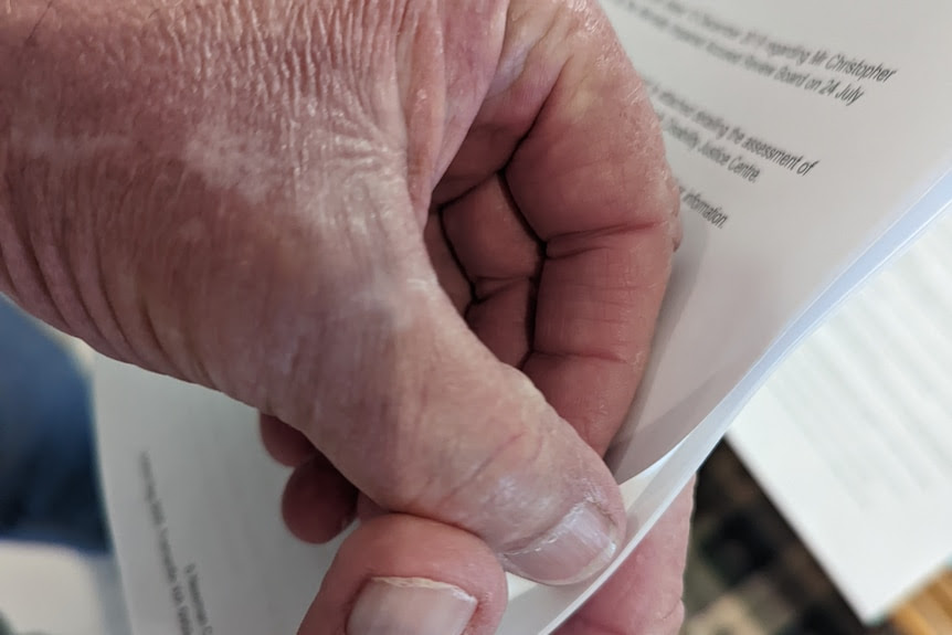 Close up of hand turning a white page.