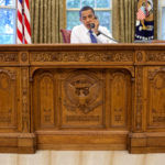 barack_obama_sitting_at_the_resolute_desk_2009