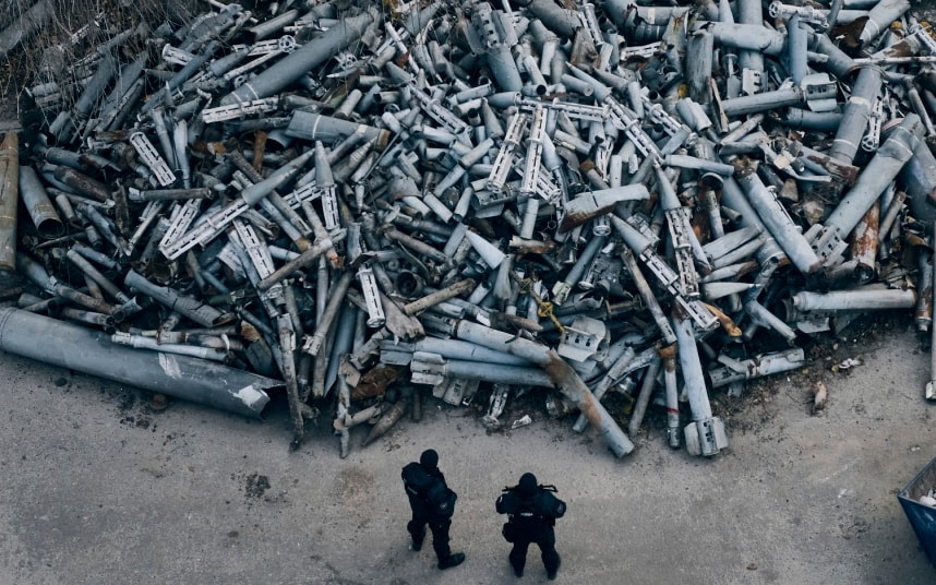 Police inspect a huge pile of spent rocket casings from missiles used by the Kremlin in Kharkiv.