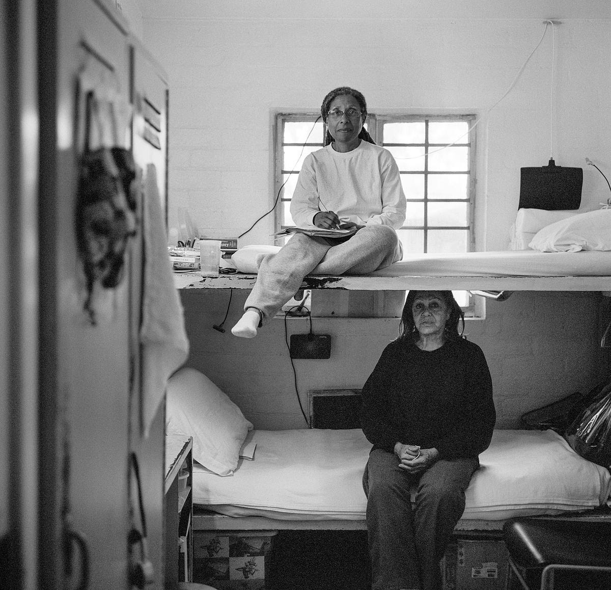 Adrienne Davidson, top, 61, and Eliana Sotomayor, 77, sit in their cell in March 2023, at the California Institution for Women in Chino, CA. 
