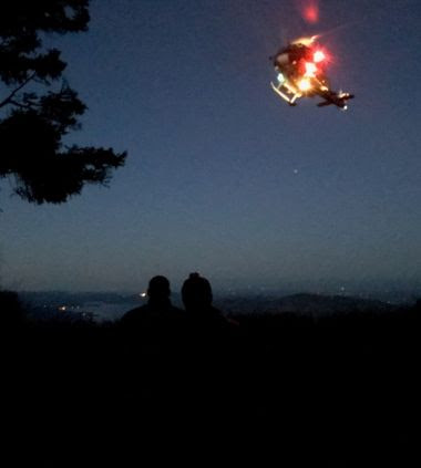 a helicopter in the dark night sky with lights on