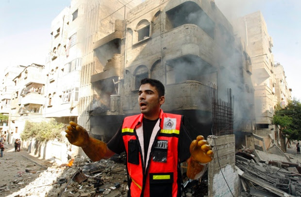 A member of the civil defence reacts after what police said was an Israeli air strike on a house.