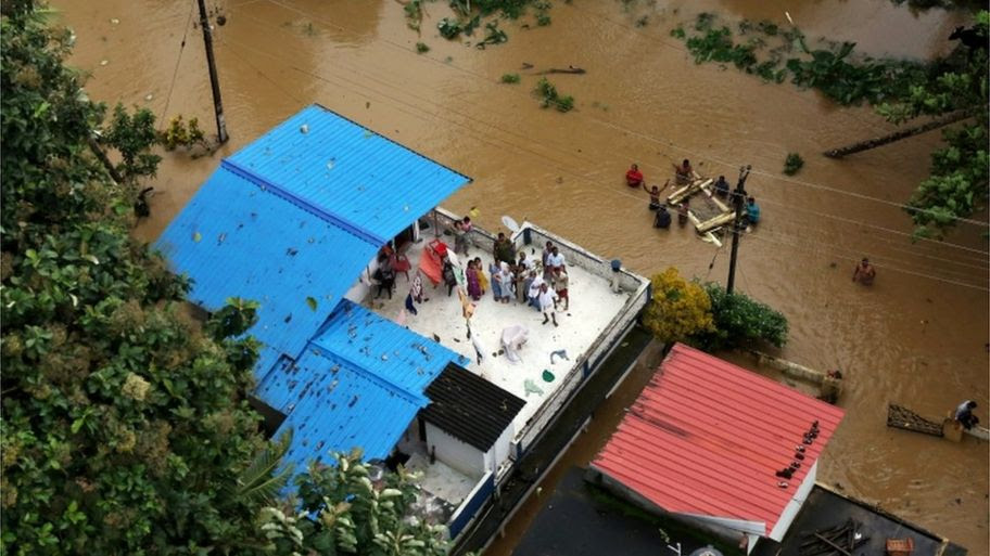 people on a Kerala rooftop waiting to be rescued