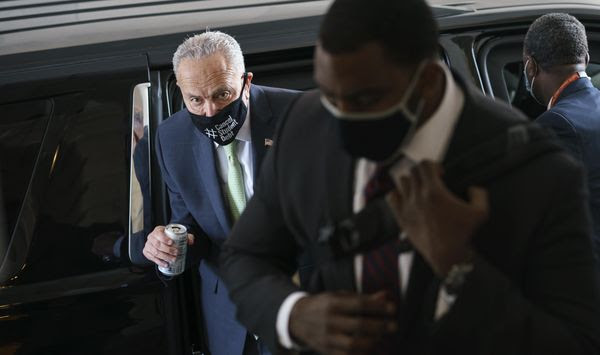 Senate Majority Leader Chuck Schumer, D-N.Y., arrives with his security detail as senators convene for a rare weekend session to continue work on the $1 trillion bipartisan infrastructure bill, at the Capitol in Washington, Sunday, Aug. 8, 2021. (AP Photo/J. Scott Applewhite)