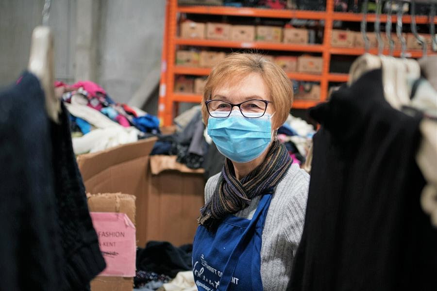Volunteer in clothing warehouse