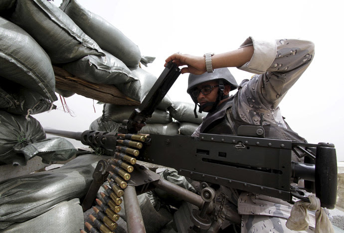 A Saudi soldier loads ammunition at their position at Saudi Arabia's border with Yemen April 6, 2015. (Reuters/Faisal Al Nasser)