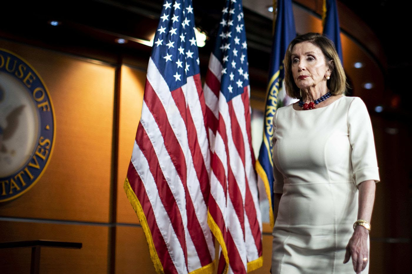 Speaker of the House Nancy Pelosi walking across a stage