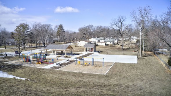 A photo of the newly renovated Creekside Park taken in winter is shown. 