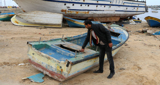Ahmad Abu Hamadah by his boat, now out of commission. Photo by Muhammad Sabah, B'Tselem, 26 Jan. 2017