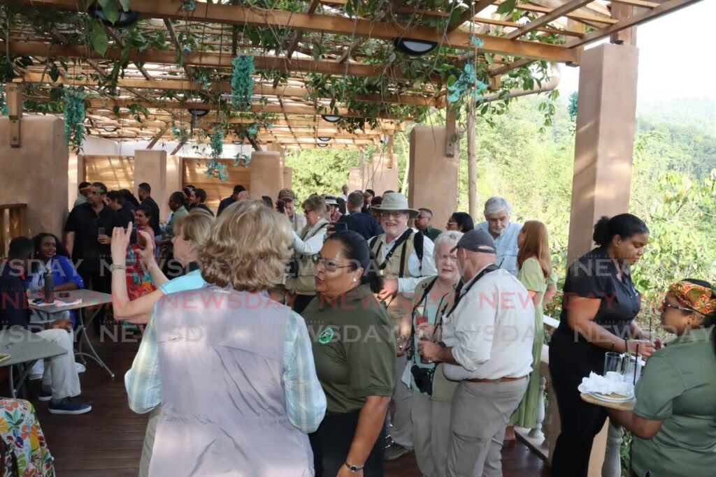 Guests enjoy the view while mingling in the main lounge of Asa Wright Nature Centre during its reopening under Hadco Experiences on April 6. - Photo by Roger Jacob