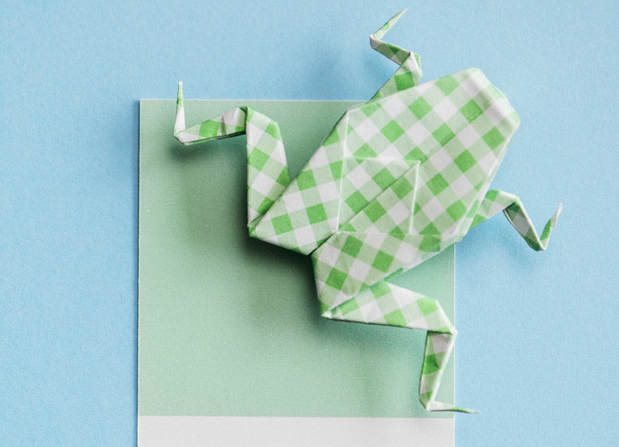 Origami frog made out of green and white paper Origami frog made out of green and white paper