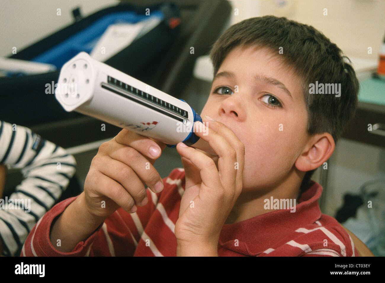 Man Blowing Into A Peak Flow Meter To Check From Asthma